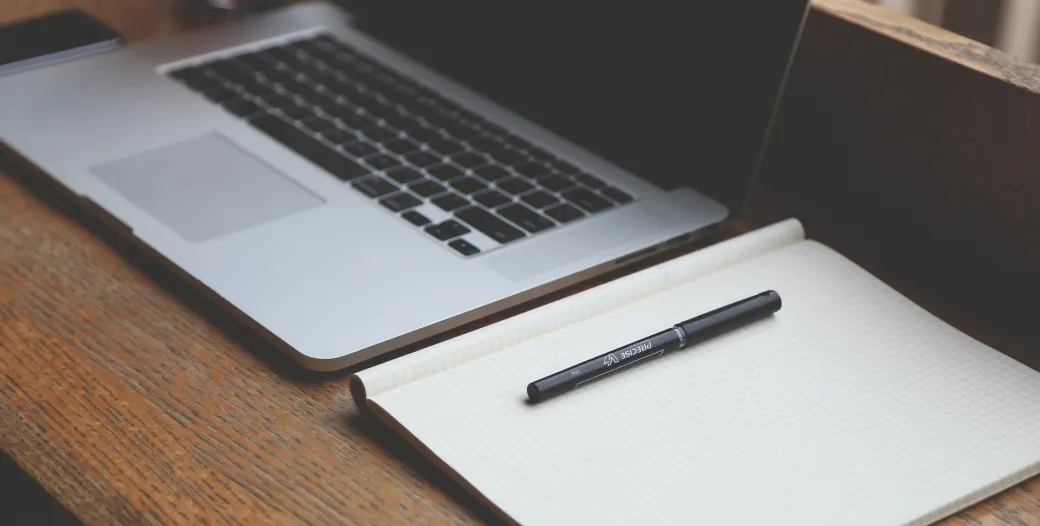 Computer and notepad on a desk